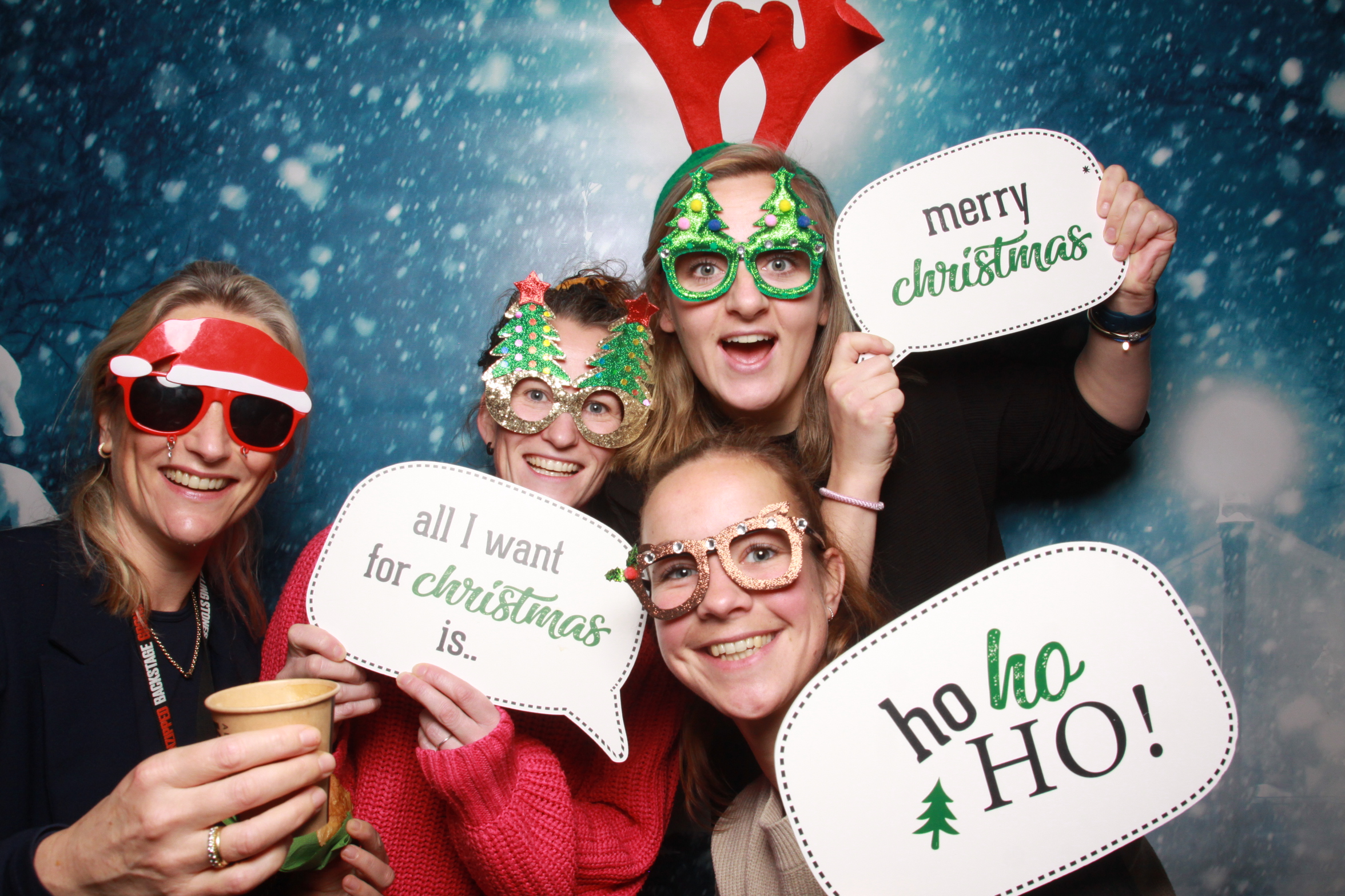 Photobooth kerstborrel: collega's met kerstmutsen en kerstprops in de photobooth